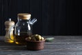 Olive oil, green olives and spices on a wooden table Royalty Free Stock Photo
