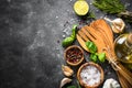 Olive oil, herbs and spices on a dark stone table. Royalty Free Stock Photo