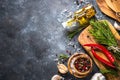 Olive oil, herbs and spices on a dark stone table. Royalty Free Stock Photo