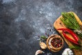 Olive oil, herbs and spices on a dark stone table. Royalty Free Stock Photo