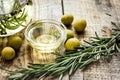 Olive oil with ingredients on kitchen table background