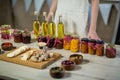 Olive oil, jam, pickle placed together on table