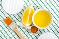 Olive oil, lemon, turmeric powder and cosmetic brush. Ingredients for preparing diy face and hair masks, scrubs and moisturizers. Royalty Free Stock Photo