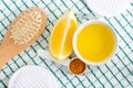 Olive oil, lemon, turmeric powder and wooden hairbrush. Ingredients for preparing diy face and hair masks and moisturizers. Royalty Free Stock Photo