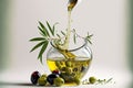 Olive oil pouring from a bottle into a glass bowl filled with olives and a branch Royalty Free Stock Photo