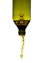 Olive oil pouring from green bottle Royalty Free Stock Photo