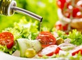 Olive oil pouring over salad Royalty Free Stock Photo