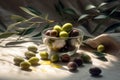 Olive oil in small glass bowl with olives and branch of olive tree with soft shadow. Royalty Free Stock Photo