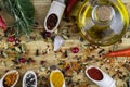 Olive oil, spices are spilled on a wooden table as a background Royalty Free Stock Photo