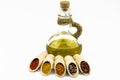 Olive oil, spices in wooden spoons isolated on a white background Royalty Free Stock Photo