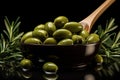 Olive oil in a spoon with green olive fruits, culinary background