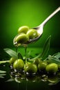 Olive oil in a spoon with green olive fruits, culinary background