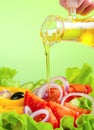 Olive oil stream and healthy fresh vegetable salad