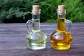 Olive oil and sunflower oil in decanter on a brown wooden table.Healthy food. Carafe with oil. The oil container
