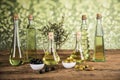 Olive oil, olive tree and green and black olives on a wooden table Royalty Free Stock Photo