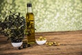 Olive oil, olive tree and green and black olives on a wooden table Royalty Free Stock Photo