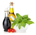 Olive oil and vinegar bottles with basil and tomatoes Royalty Free Stock Photo