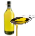 Olive oiled poured from a spoon Royalty Free Stock Photo