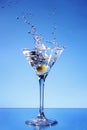 Olive splashing in a Martini glass Royalty Free Stock Photo