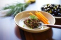 olive tapenade in a stylish dish with a decorative knife