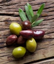 Olive twig and olives on old wooden table. Royalty Free Stock Photo