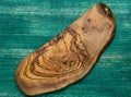 Olive wood cutting board on wooden background Royalty Free Stock Photo