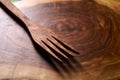 Olive wood fork on wooden cutting board
