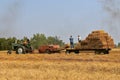 Oliver tractor and New Holland baler harvesting hay Royalty Free Stock Photo