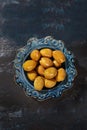 Olives in a blue ceramic plate. Healthy natural food. A powerful antioxidant and a healthy product. Top view. Blue background.