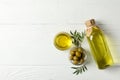 Olives, bottle and bowl with olive oil on background, top view Royalty Free Stock Photo