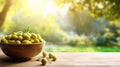 Olives in a bowl against the backdrop of the garden. Selective focus. Royalty Free Stock Photo