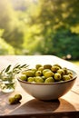 Olives in a bowl against the backdrop of the garden. Selective focus. Royalty Free Stock Photo