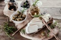 Olives are green and black with soft cheese with mold like brie, Camembert with olive oil and thyme. Cheese and olives Royalty Free Stock Photo