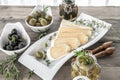 Olives are green and black with soft cheese with mold like brie, Camembert with olive oil and thyme. Cheese and olives in an olive Royalty Free Stock Photo