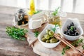 Olives are green and black with soft cheese with mold like brie, Camembert with olive oil and thyme Royalty Free Stock Photo
