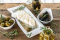 Olives are green and black with soft cheese with mold like brie, Camembert with olive oil and thyme Royalty Free Stock Photo