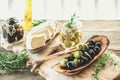 Olives are green and black with soft cheese with mold like brie, Camembert with olive oil and thyme. Cheese and olives Royalty Free Stock Photo