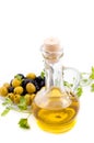 Olives and oil in jug with greens Royalty Free Stock Photo