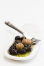 Olives, oil and spice on white plate Royalty Free Stock Photo