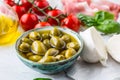 Olives olive oil mozzarella cheese tomatoes prosciutto basil leaves - ingredients italian or mediterranean cuisine Royalty Free Stock Photo