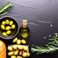 Olives, olive oil rosemary and bread on black slate background. Top view copy space Royalty Free Stock Photo