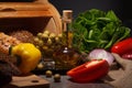 Olives, olive oil, vegetables and bread on a dark background Royalty Free Stock Photo