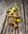 Olives with rosemary and olive oil on a wooden background