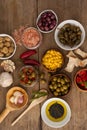 Olives with spice and corns with oil in bowl on table Royalty Free Stock Photo