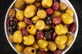 Olives variety. Black, green and brown olives, close-up overhead shot of an assortment