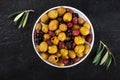 Olives variety. Black, green and red olives, shot from the top on a black background