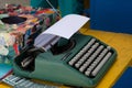 Olivetti Lettera 82 green typewriter on top of a table, with paper inside. Salvador, Bahia