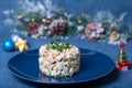 Olivier salad on a blue plate, decorated with pea sprouts. Traditional New Year and Christmas Russian salad Royalty Free Stock Photo