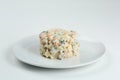 Olivier salad on white plate. vegan version of traditional russian salad Olivier from boiled vegetables Royalty Free Stock Photo