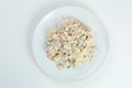 Olivier salad on white plate. vegan version of traditional russian salad Olivier from boiled vegetables Royalty Free Stock Photo